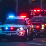 Ambulance Flood Jolts Concert Crowd Police SUV and ambulance with flashing lights at night