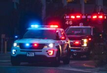 Ambulance Flood Jolts Concert Crowd Police SUV and ambulance with flashing lights at night