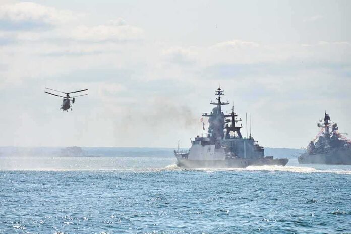 shutterstock_2060995196 military ships and helicopter at sea