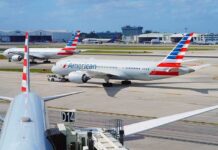 American Airlines jets taxi at a busy airport apron