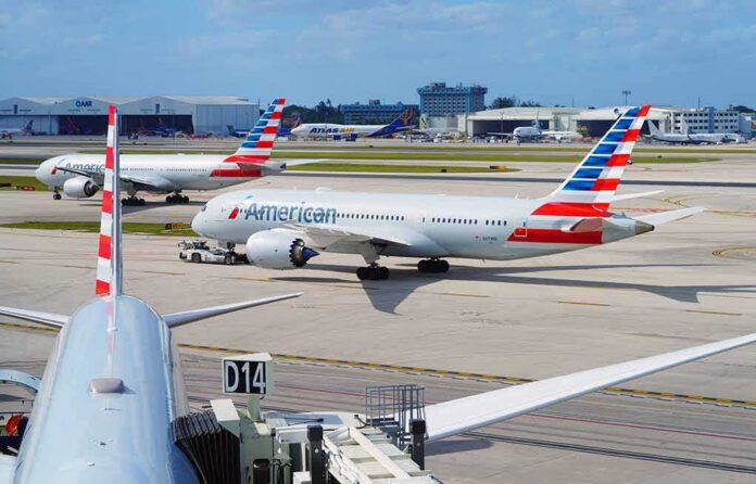 American Airlines jets taxi at a busy airport apron