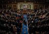 Congressional Freeze Threatens AI Data Centers Legislative chamber audience stands and applauds