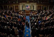 Congressional Freeze Threatens AI Data Centers Legislative chamber audience stands and applauds