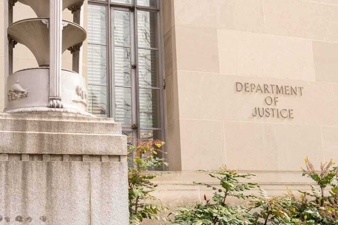 shutterstock_2271133921-1 Department of Justice building facade with stone sign and window
