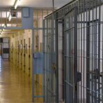 Ex-Deputy Dies After Prison Release Denial Prison corridor with barred doors