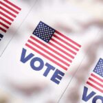 Billionaire Chill Freezes Harris Hopes American flag vote posters on a table