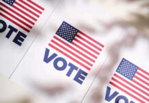 Billionaire Chill Freezes Harris Hopes American flag vote posters on a table