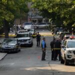 Juvenile Manslaughter Shocks D.C. Court Police officers secure a residential street with patrol cars and yellow tape