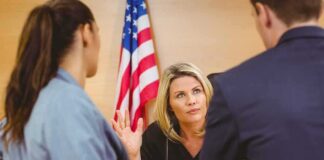 Judge speaking with two attorneys at the bench in a courtroom