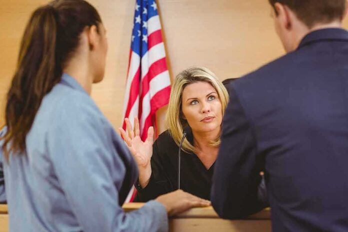 Judge speaking with two attorneys at the bench in a courtroom