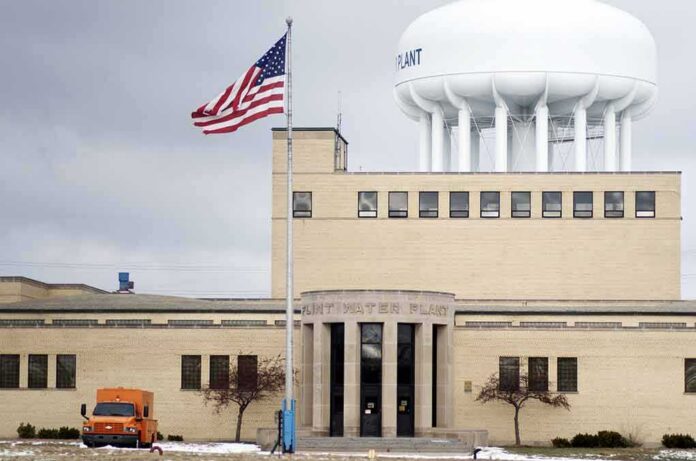 Water treatment plant with US flag and large white water tower