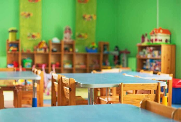 shutterstock_511391014 Preschool classroom with small tables and wooden chairs