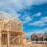 Wood-framed house under construction in a suburban neighborhood