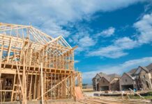 Hypocrisy Howl Masks Costly Permit Snag Wood-framed house under construction in a suburban neighborhood