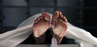 Human feet with toe tag on a morgue gurney