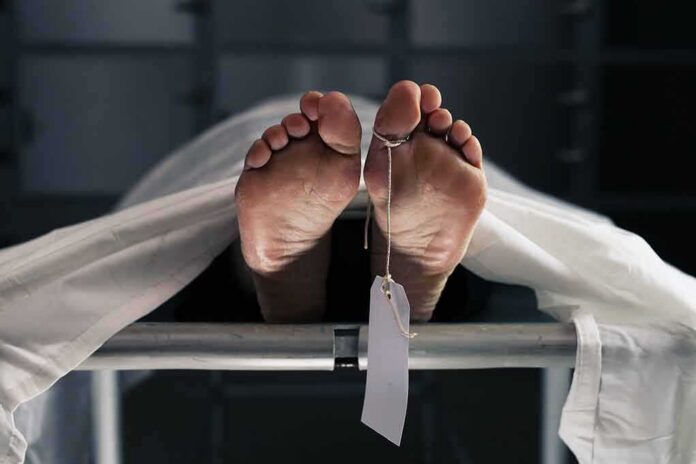 Human feet with toe tag on a morgue gurney