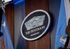 Fort Hood Killer’s Final Order Signed The Pentagon emblem between two flags.