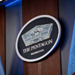 Fort Hood Killer’s Final Order Signed The Pentagon emblem between two flags.