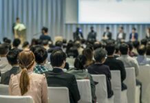 Bill Kenney at a conference panel with an audience