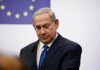 Netanyahu Judgment Day Begins man in suit at podium with EU flag in background