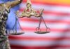Lady Justice scales with American flag background