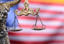 Lady Justice scales with American flag background
