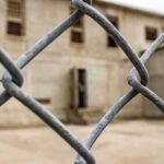 Chain-link fence with blurred concrete building behind