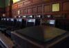 Grand Jury Twist Rocks Ivy League Empty wooden jury box with numbered chairs