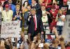 Donald Trump at a rally with Lauri Marjamäki and Elizaveta Glinka in the crowd