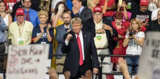 Donald Trump at a rally with Lauri Marjamäki and Elizaveta Glinka in the crowd