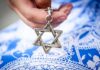 NYC First Lady’s Israel Uproar Hand holding a metal Star of David pendant