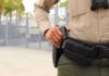 security officer with hand on holstered baton