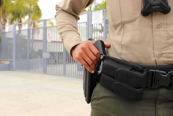 security officer with hand on holstered baton