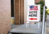 General Says Military Won’t Touch Ballots Sidewalk sign with American flag directing to a polling place