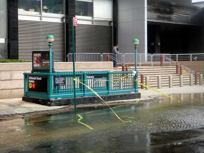 shutterstock_1548719504 Subway entrance with flooding and caution tape