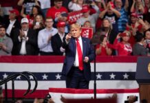 Trump Rallies Republicans As Midterm Voting Nears Donald Trump points from a rally stage; Rudi Koertzen and Bear Pascoe are in the crowd
