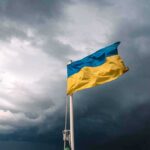 Battlefield Link Crippled From Inside Ukrainian flag waving against a stormy sky