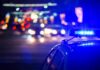 Police car with flashing blue lights at night