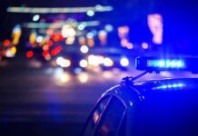 Police car with flashing blue lights at night
