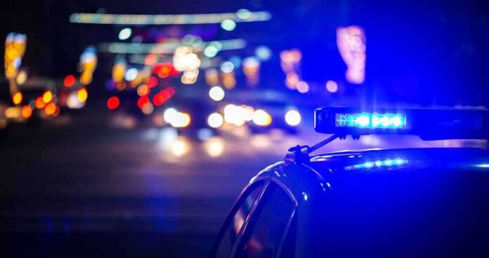 Police car with flashing blue lights at night