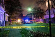 Resort Bloodbath Shocks Great Wolf Lodge Police car blocks residential street at night behind caution tape