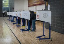 Texas Opens Early Voting With New Record Voters at polling booths in a gymnasium