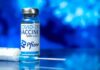 Consumer-Fraud Fight Puts Pfizer On Notice Pfizer COVID-19 vaccine vial with syringe on blue background