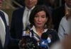 Emergency Powers UNLEASHED In NYC Woman speaking to reporters at a press scrum