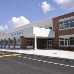 Diploma Mill Allegations Rock Nashville Modern school building with large windows and a clear sky