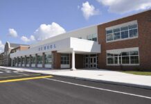 Diploma Mill Allegations Rock Nashville Modern school building with large windows and a clear sky