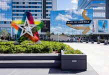 Mall entrance with colorful star sculpture and mirrored facade