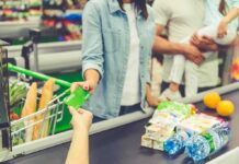 Customer paying with a card at a supermarket checkout