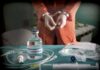 Execution Chaos Shocks Tennessee Medical vials and IV lines on a table with a handcuffed person in the background