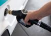 Trump Bets on Russian Diesel A hand holding a diesel fuel nozzle while refueling a vehicle
